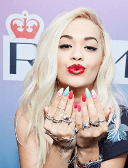 Rita is wearing lip gloss and high shine polish from her collection